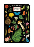 2027 Cavallini & Co. Foraging Weekly Planner with a black cover decorated with vintage-style botanical illustrations including flowers, mushrooms, a fern, a pinecone, berries, and a butterfly. The elastic closure band is black.