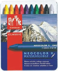 A set of Caran d'Ache Neocolor II water soluble pastels in a tin, with a mountainous landscape in the background.