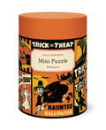 A cylindrical puzzle box for a Halloween mini puzzle, featuring an orange lid and a colorful Halloween-themed label with illustrations of a witch, pumpkin, ghost, and bats. The label reads 'TRICK OR TREAT HALLOWEEN Mini Puzzle 240 pieces' and 'HAUNTED HALLOWEEN'.