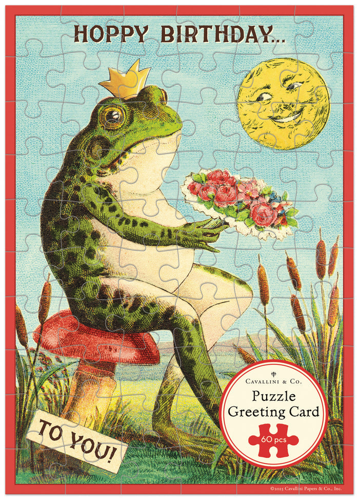 Cavallini & Co. Happy Birthday Frog Puzzle Greeting Card
- Frog with flowers and crown on a mushroom, surrounded by nature elements, with 'Happy Birthday' text