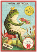 Cavallini & Co. Happy Birthday Frog Puzzle Greeting Card
- Frog with flowers and crown on a mushroom, surrounded by nature elements, with 'Happy Birthday' text