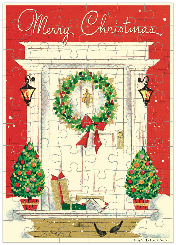 Christmas-themed puzzle greeting card with wreath, trees, and presents on a red background