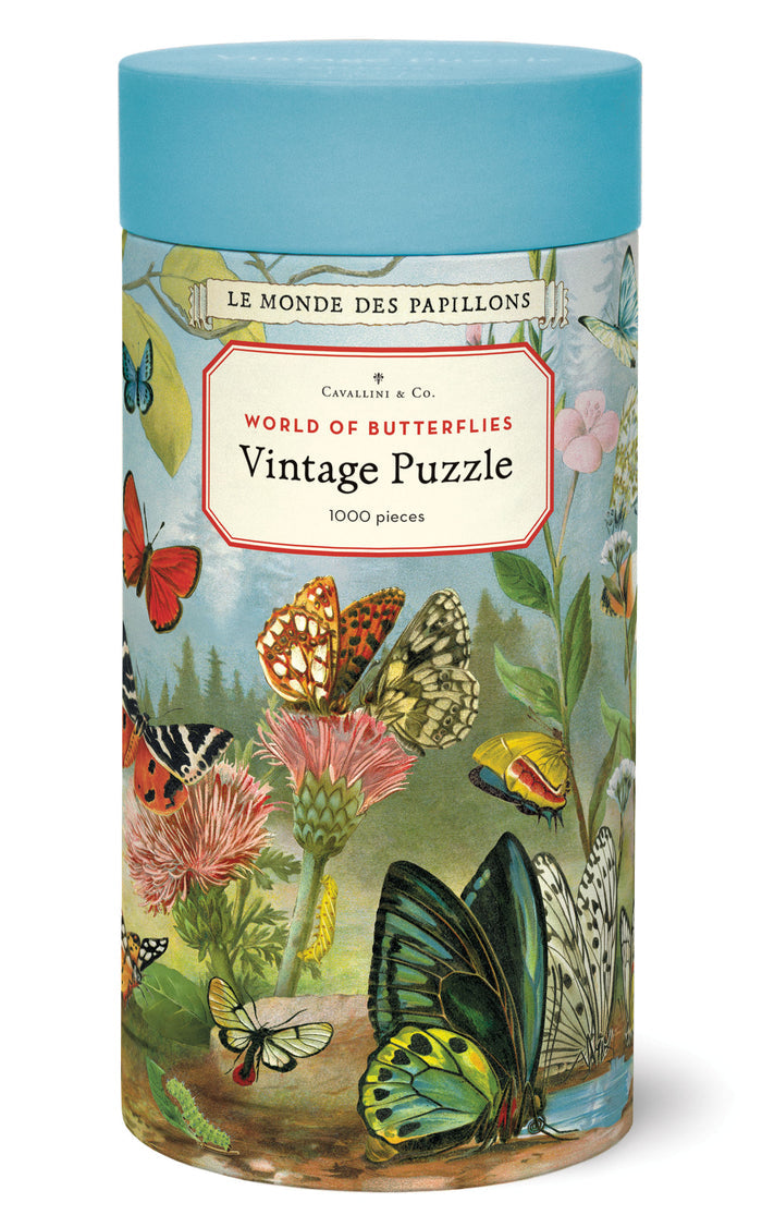 Cavallini & Co. World of Butterflies 1000 Piece Puzzle packaging- cylindrical puzzle box with butterfly design and blue lid