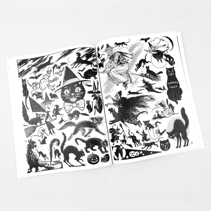 Open book with black and white illustrations of cats on a white background