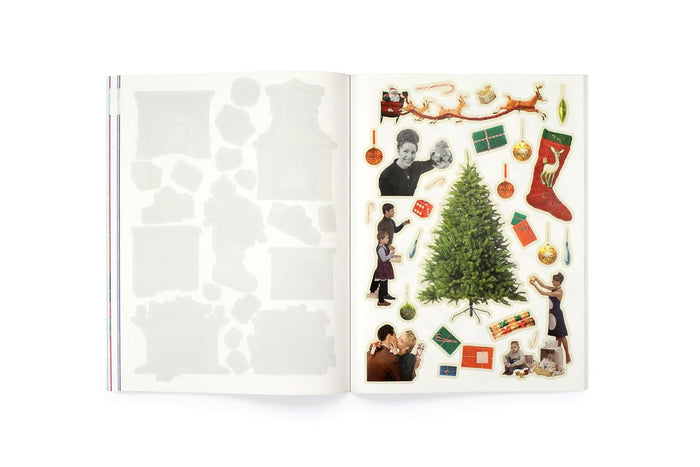 Open book with Christmas-themed stickers on a white background