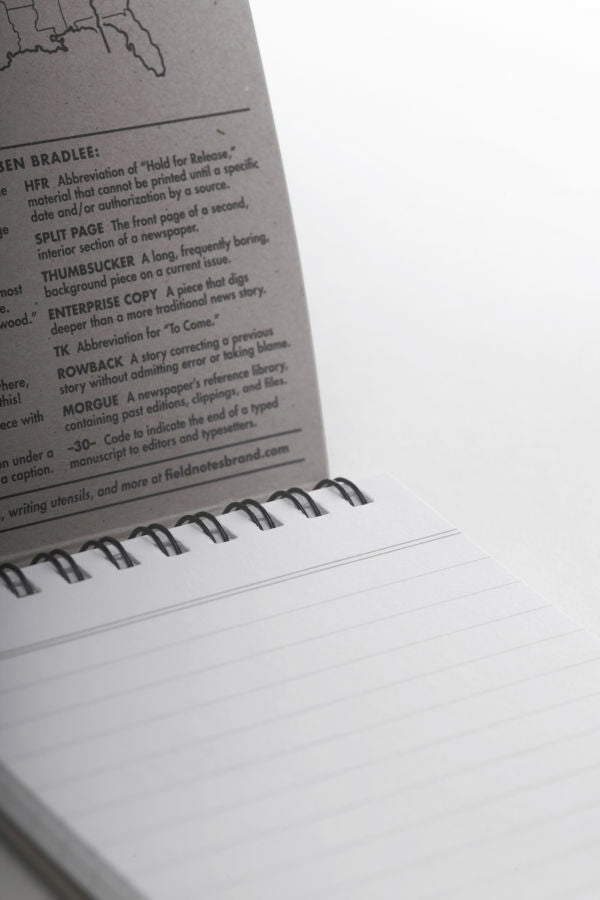 The Front Page notebook features a black top spiral.