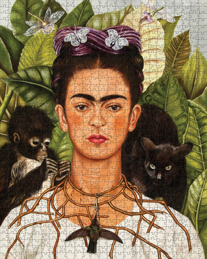 Frida Kahlo puzzle with a monkey, black cat, and butterfly on green leaves- finished puzzle example