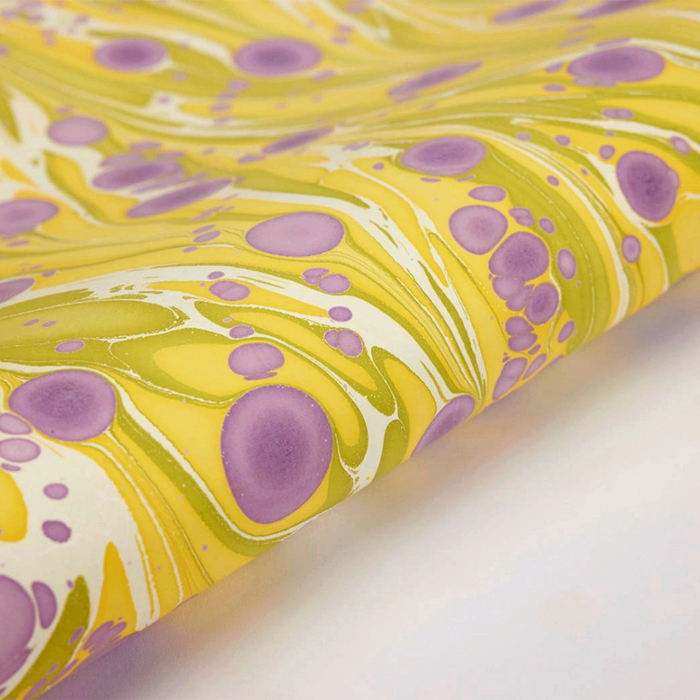 Handmade Indian Cotton Paper- Marbled Cosmos- yellow, white, green with purple circular patterns- detail