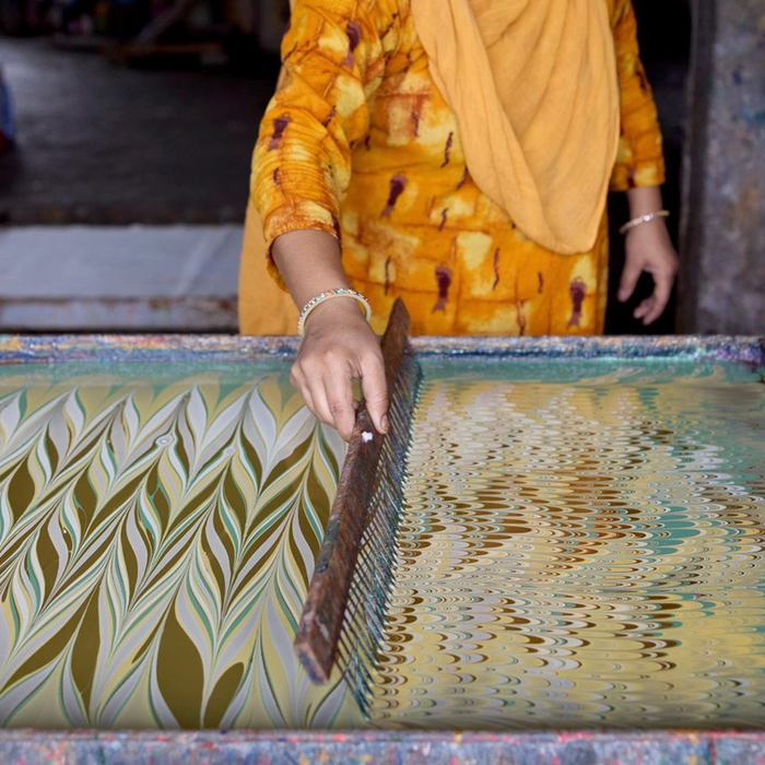 Handmade Indian Cotton Paper- Marbling work in progress. combing the pattern into the paint