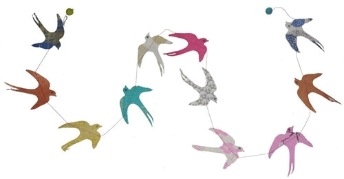 The Handmade Lokta Paper Swallow Garland features colorful swallows sewn together by a Nepalese women's cooperation.