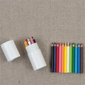 Mini Colored Pencil Capsule set of 12- images shows a set of mini colored pencils displayed next to an open white tube on a beige background.