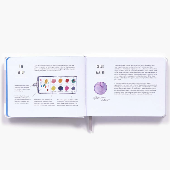 An open Color A Day page spread showing printed instructions and color reference pages, photographed on a clean white background.