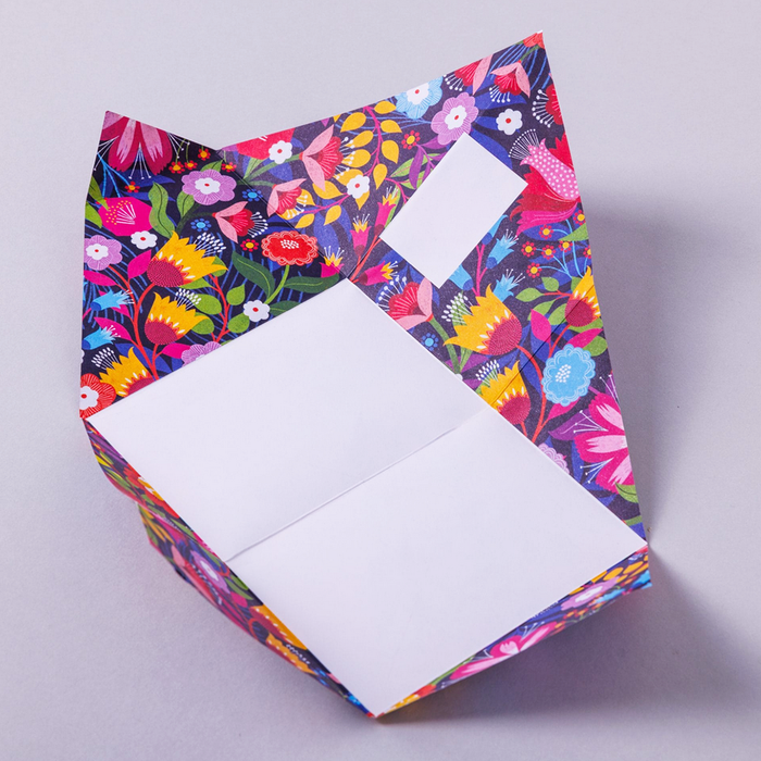Colorful floral-patterned writing paper with a white square inside for writing on a light gray background