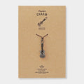 Ukulele-shaped charm on a brown card with 'Traveler's Factory' branding.