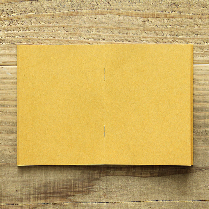 TRAVELER'S FACTORY Passport Refill features yellow kraft paper.