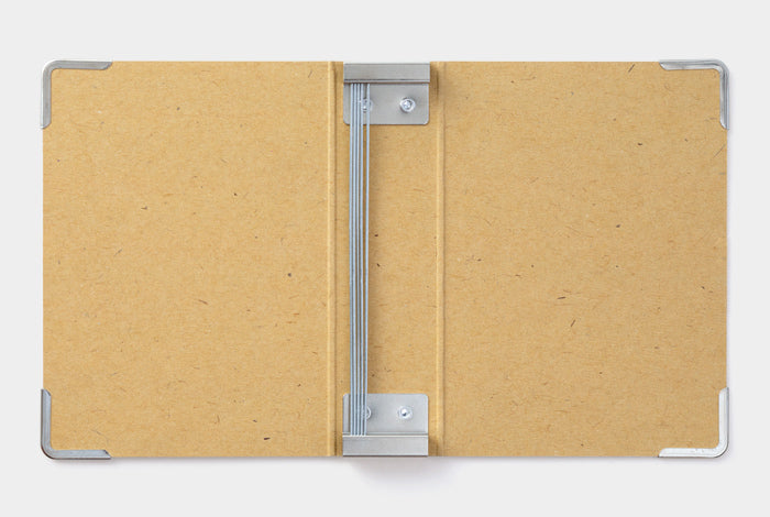 The Storage Binder uses metal rods to hold Midori Traveler's Notebook Refills.