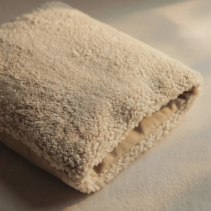 Folded 'Wool Lounge Spare Cover' on a light surface.