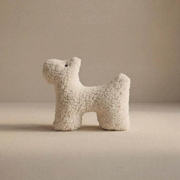 A small wool plush pet toy featuring a bouclé loop textured material, standing on a neutral beige background.