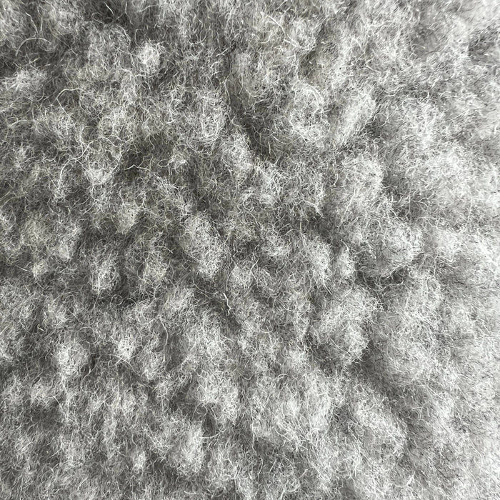 Soft wool sheep bouclé pet bed by with plush, natural fabric and a rounded shape for comfortable pet lounging.